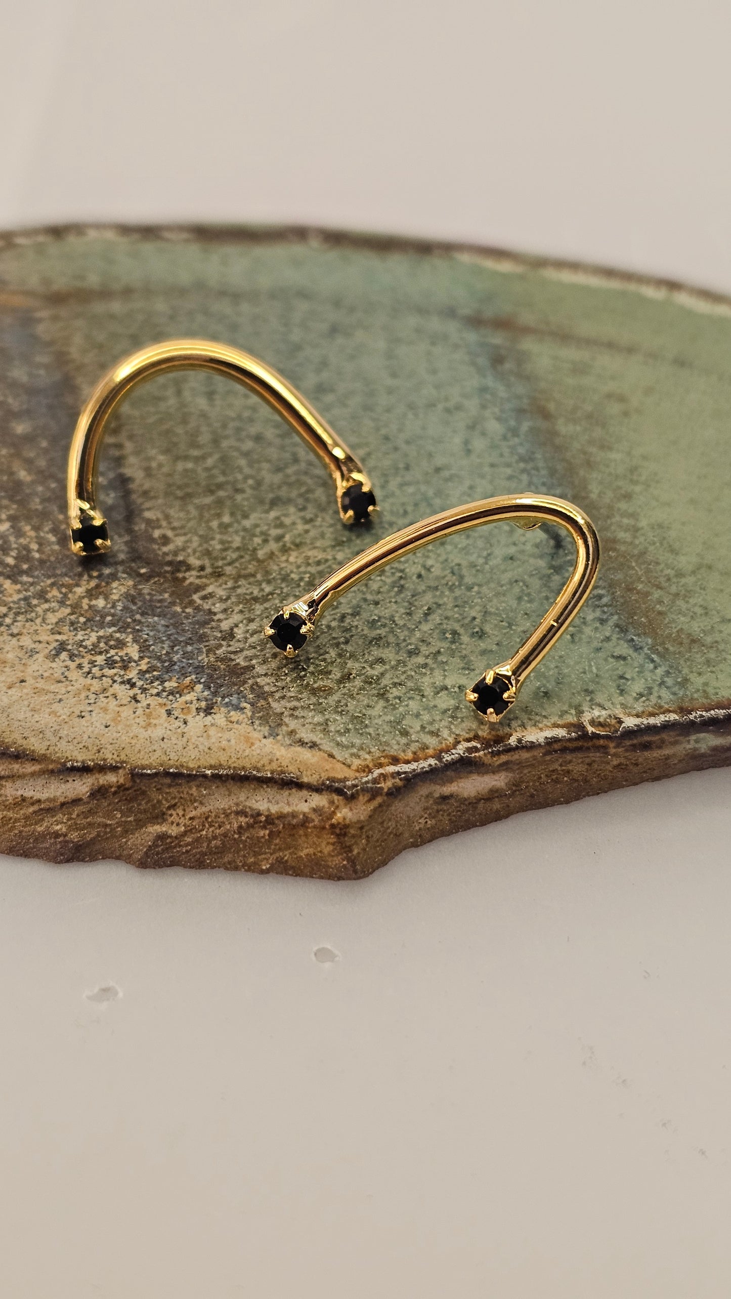 Curved golden Earrings with Black Zircons – Modern Minimalism
