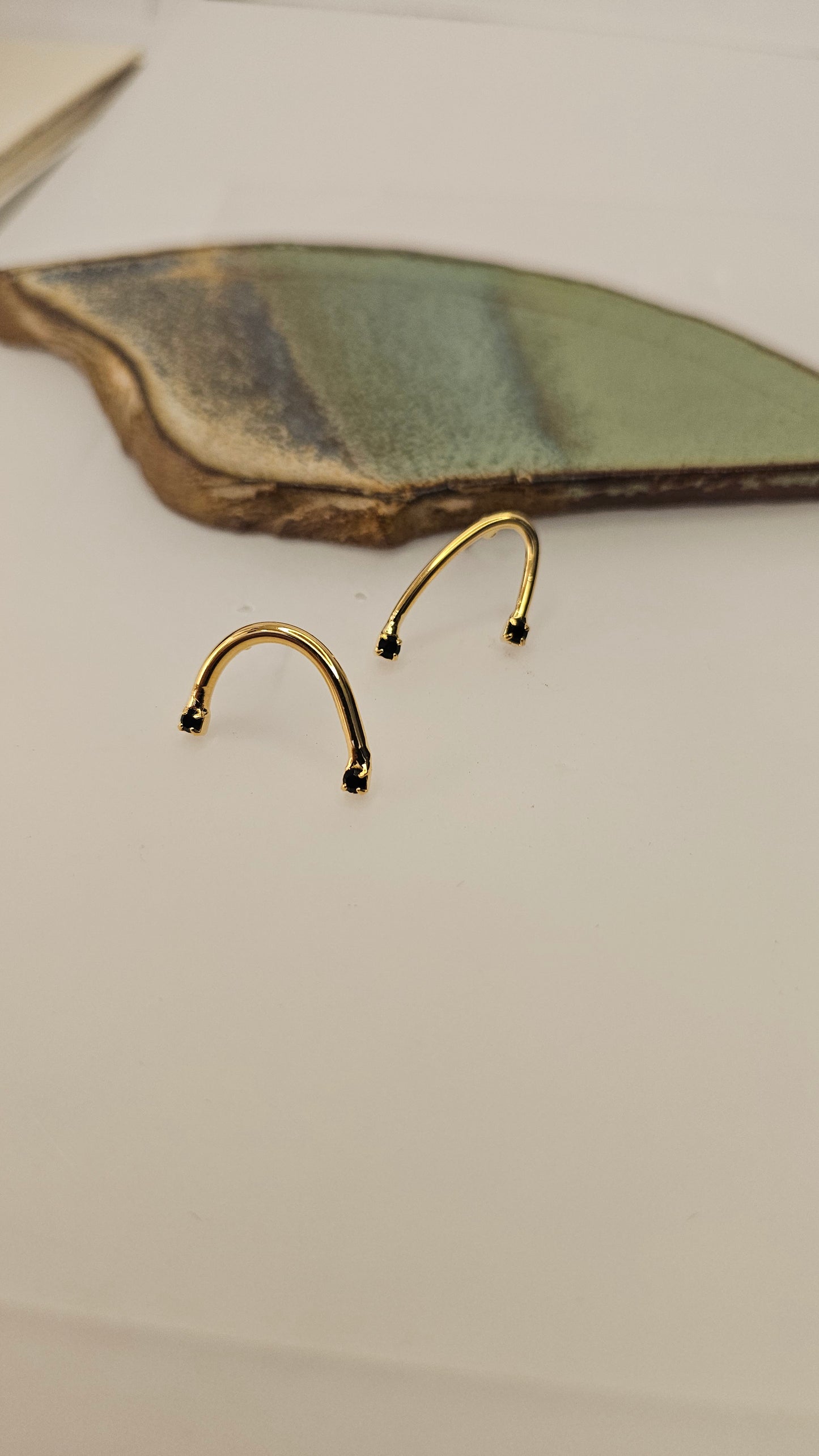 Curved golden Earrings with Black Zircons – Modern Minimalism