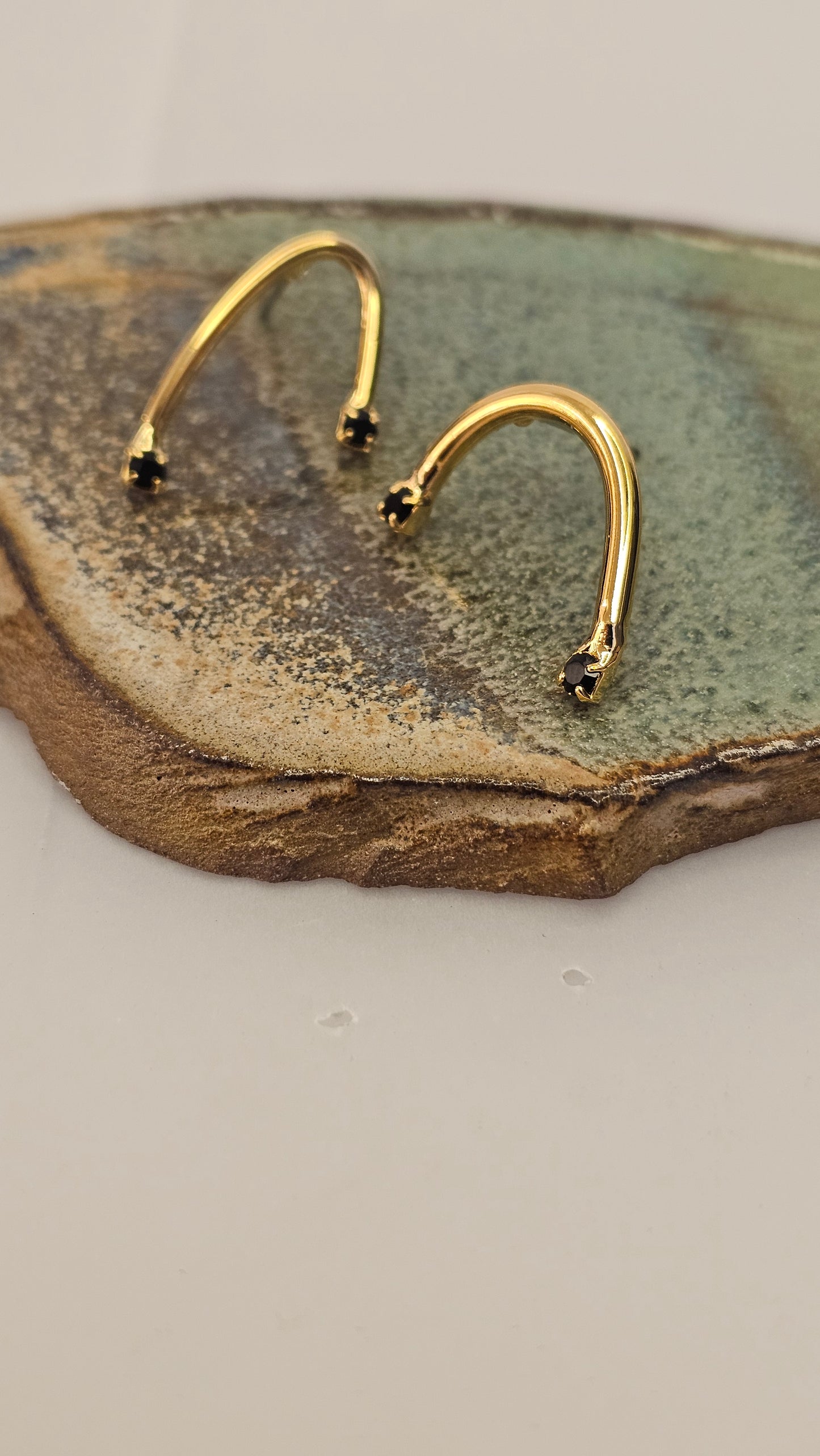 Curved golden Earrings with Black Zircons – Modern Minimalism