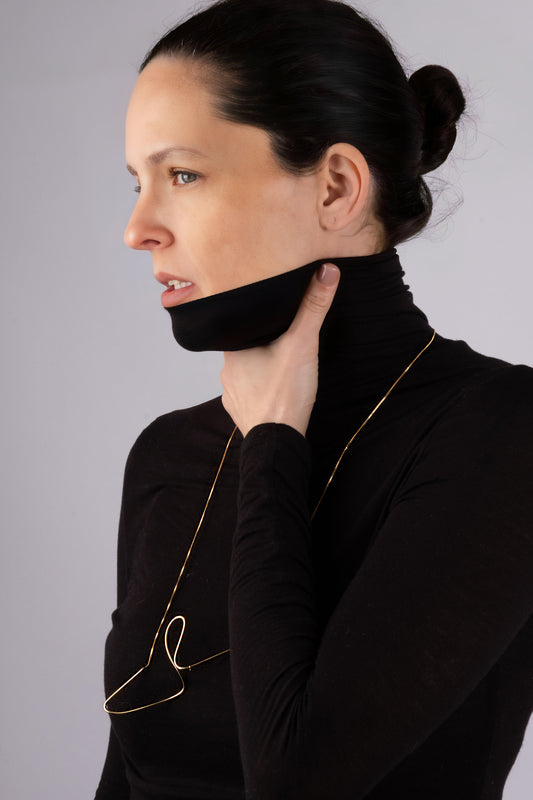 a woman wearing a black turtle neck sweater
