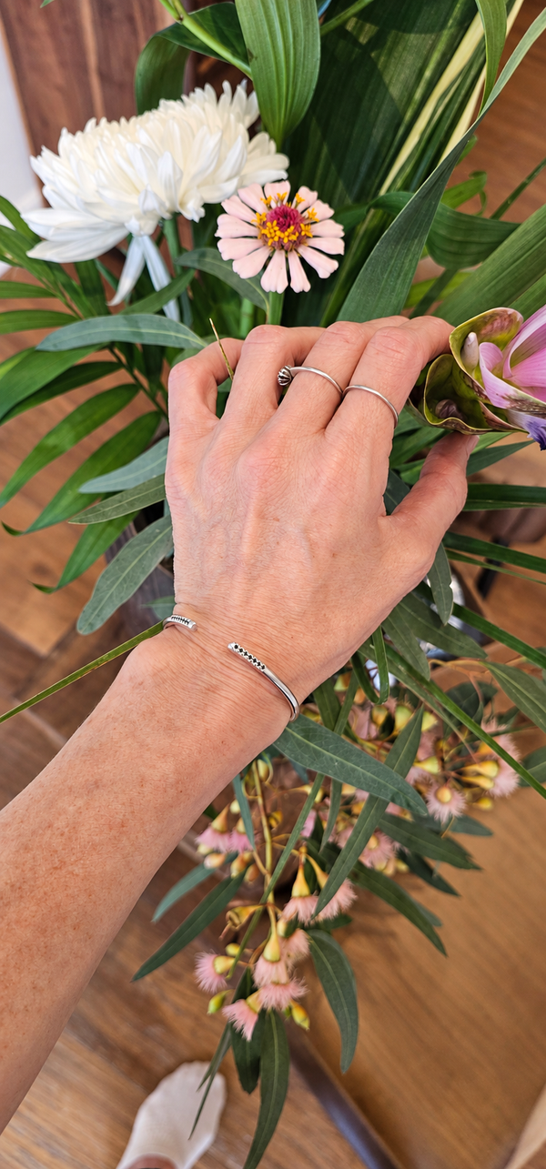 Bangle with black stones, sterling silver — studio photo