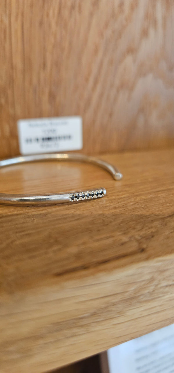 Bangle with black stones, sterling silver — studio photo