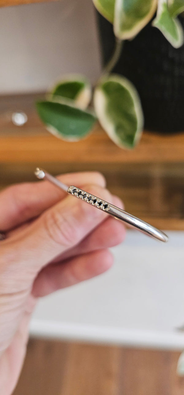Bangle with black stones, sterling silver — studio photo