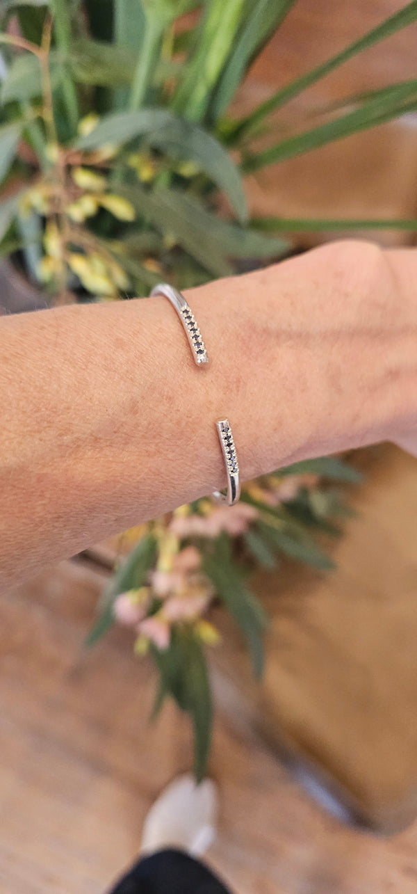 Bangle with black stones, sterling silver — studio photo