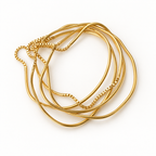 OTILYAS Hurricane Nº 8924, set of 5 gold-plated brass bracelets, one of a kind, top view on white
