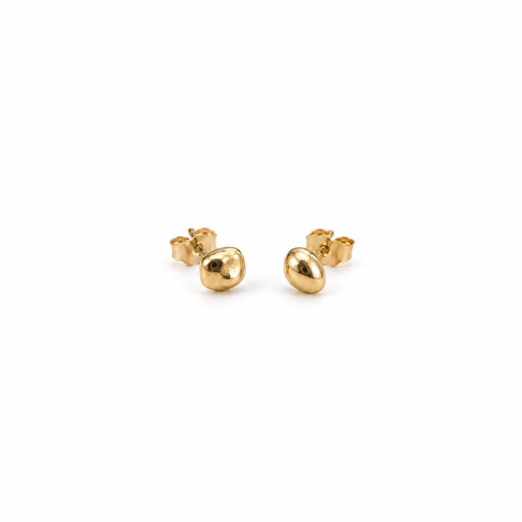 Pair of Little Studs, small irregular 14k yellow gold stud earrings, on a white background
