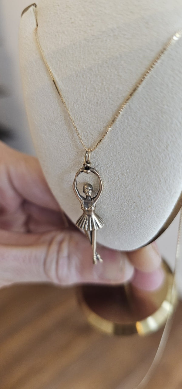 Ballerina Pendant in 14k gold on a box chain, on a display bust in the OTILYAS studio