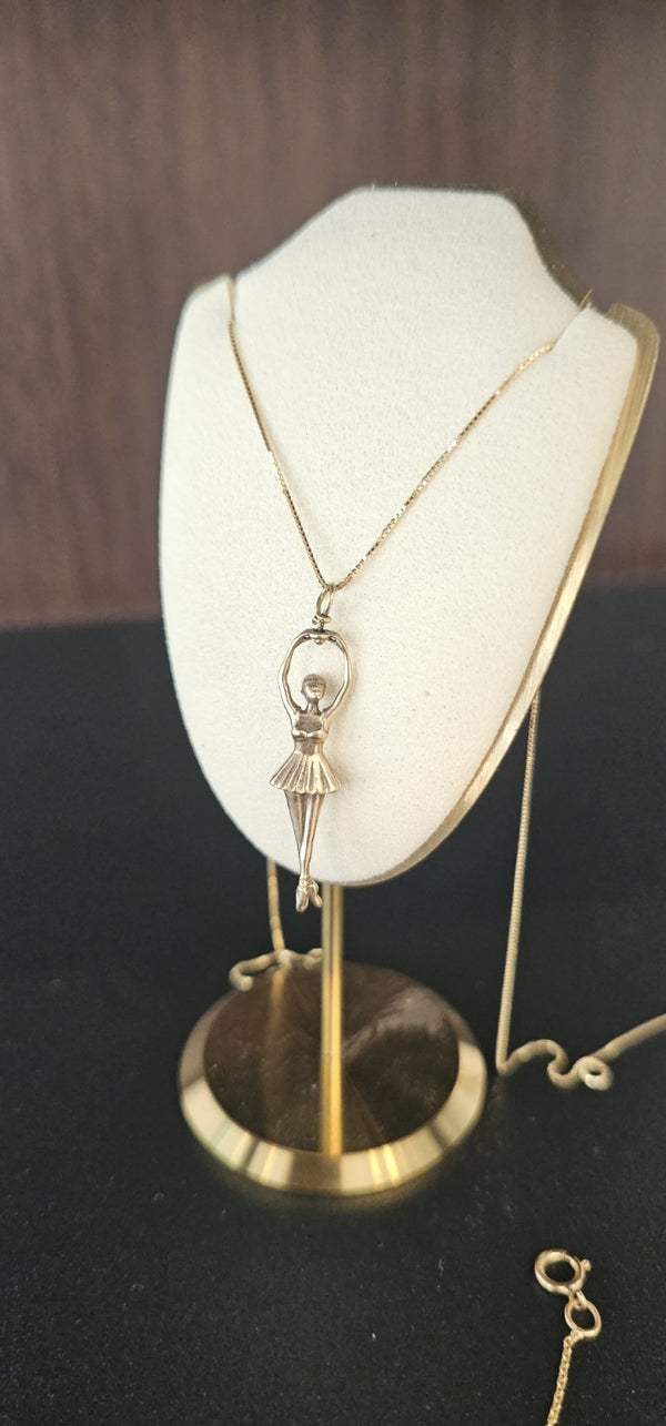 Ballerina Pendant in 14k gold on a box chain, on a display bust in the OTILYAS studio