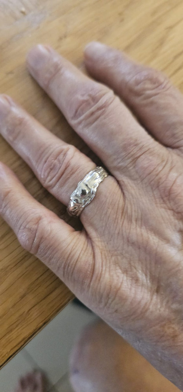 The Carmel ring on the finger, its irregular organic surface