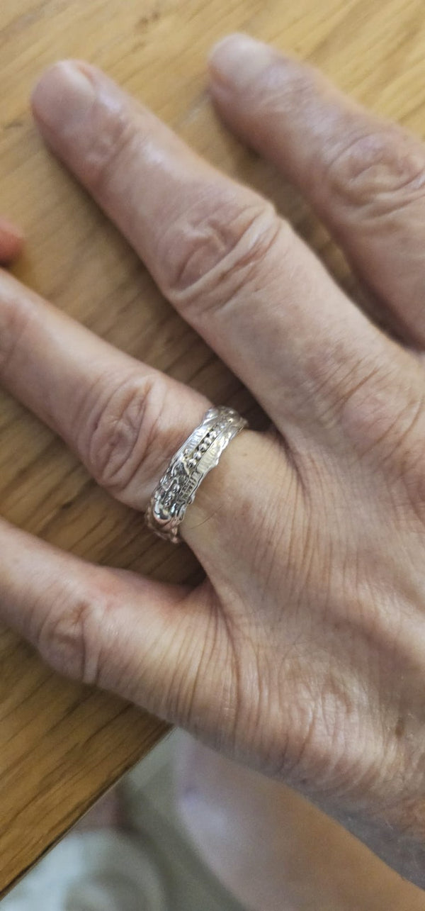 The Carmel ring worn, its textured band catching the light