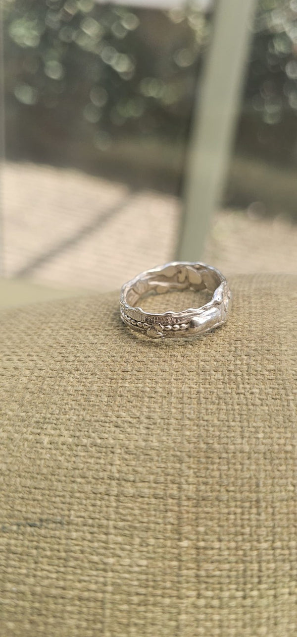 The Carmel ring standing on linen, side view of its organic texture