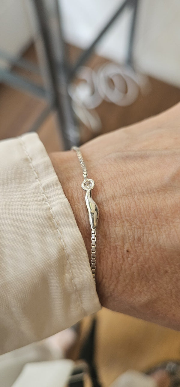 The cloud bracelet in 18k white gold with a lab-grown diamond, worn on the wrist