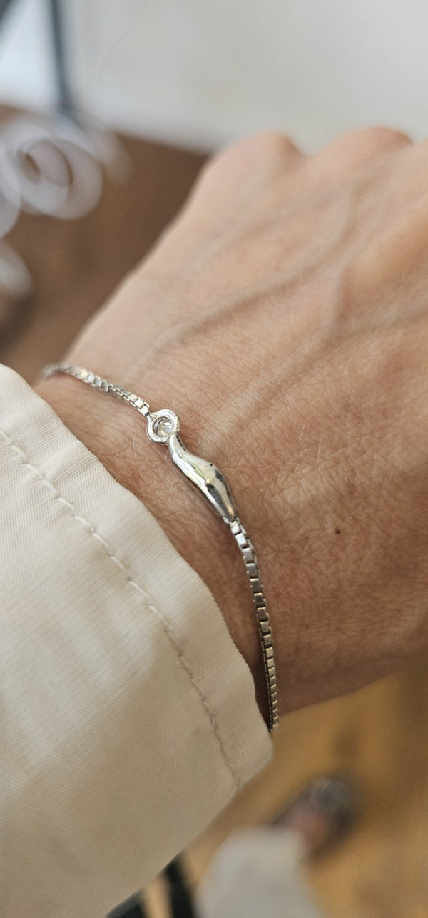 The cloud bracelet in 18k white gold with a lab-grown diamond, worn on the wrist