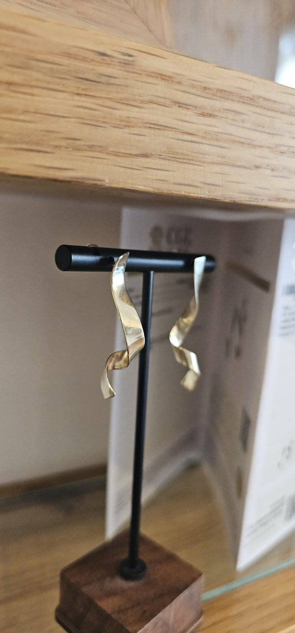 Dafnie Earrings 14k Gold on a stand in the OTILYAS studio window