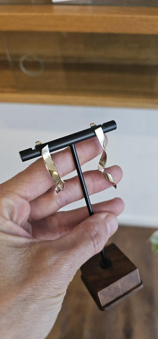 Dafnie Earrings 14k Gold on a stand held in hand in the OTILYAS studio