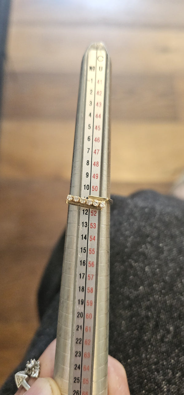 The Golden Line Ring in the OTILYAS studio, on the ring sizer