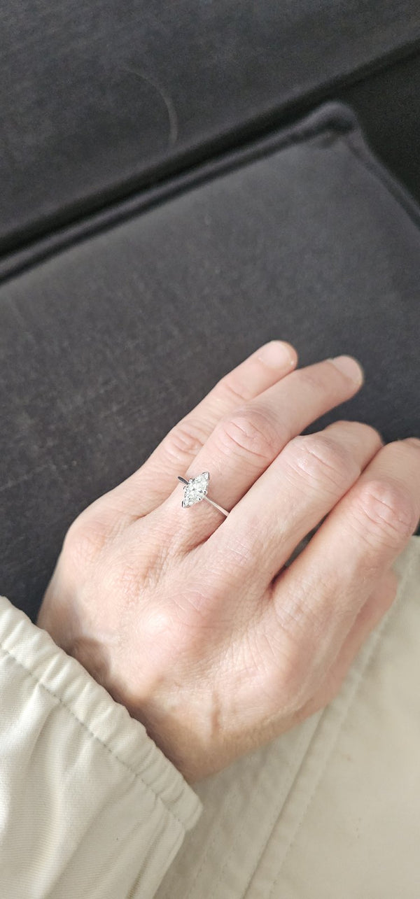 The White Leaf Ring worn on the hand, marquise diamond on a thin white gold band