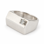 Close view of the asymmetric flat top and crown-set zircon on the sterling silver pinky ring