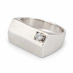 Angled view of the sterling silver signet pinky ring with its single zircon and smooth band